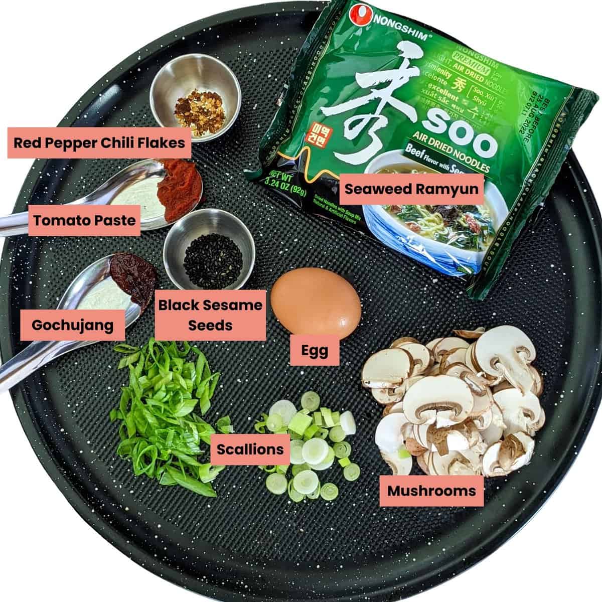 ingredients for the Beef Flavored Seaweed Ramyun with Egg, Gochujang, and Mushrooms labeled on a round sheet pan.