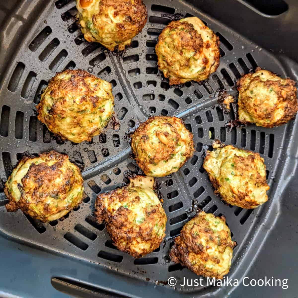 air fried meatballs in the air fryer basket evenly spread out 3 by 3