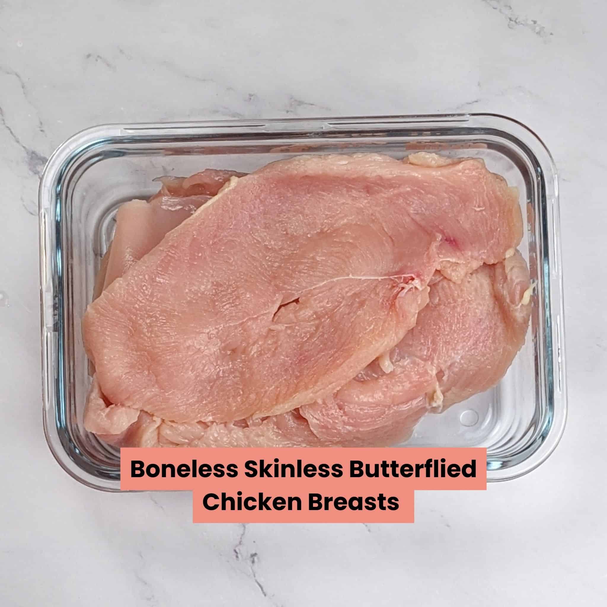 butterflied chicken breast in a glass rectangle container
