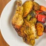 top view of the Curry spatchcocked chicken with vegetables plated in a large wide round bowl