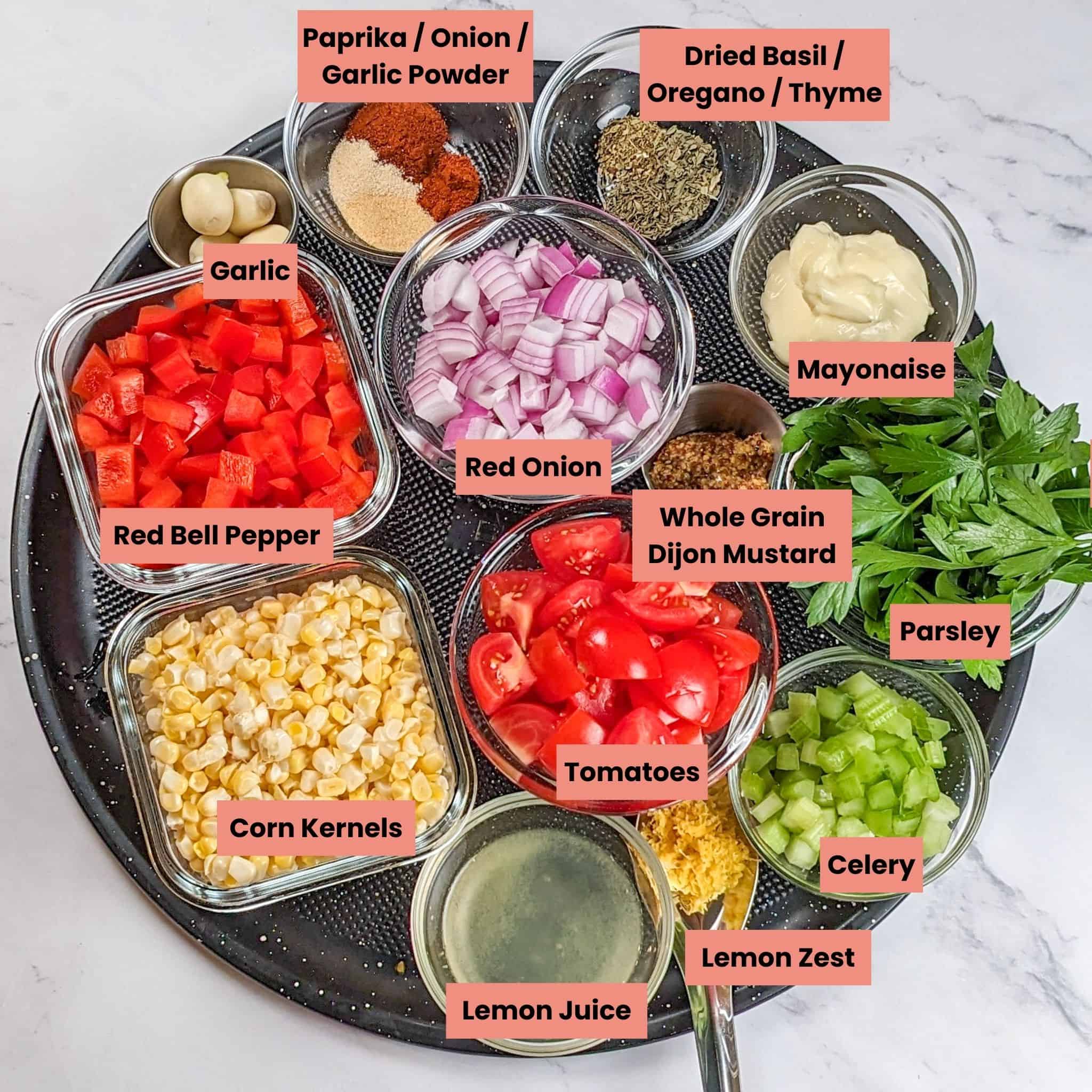 labeled ingredients for the Spicy Cajun Shrimp Rice Bowl with Lemon Remoulade in glass and stainless steel containers on a large round pizza pan.