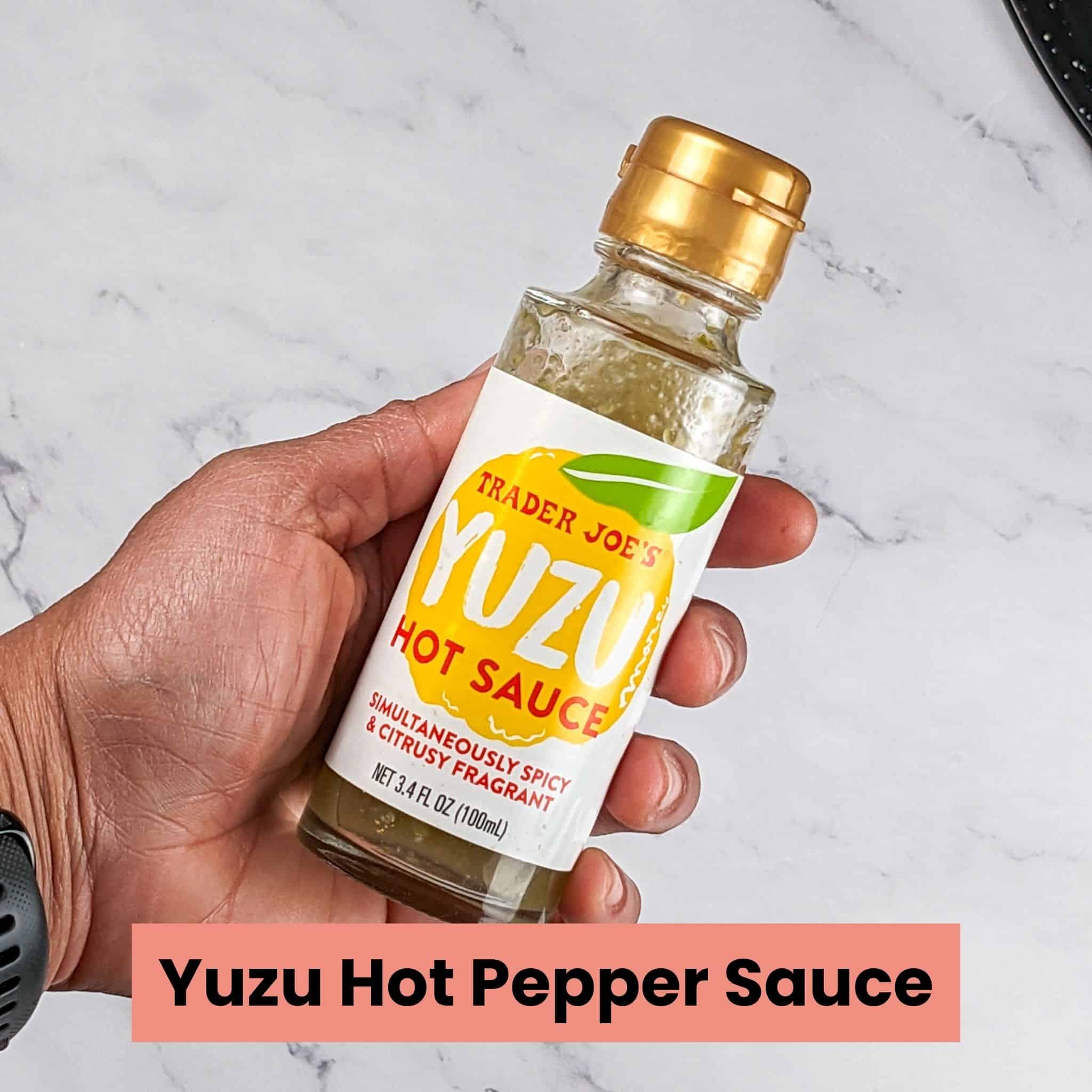 Trader Joe's Yuzu Hot Sauce held in hand.