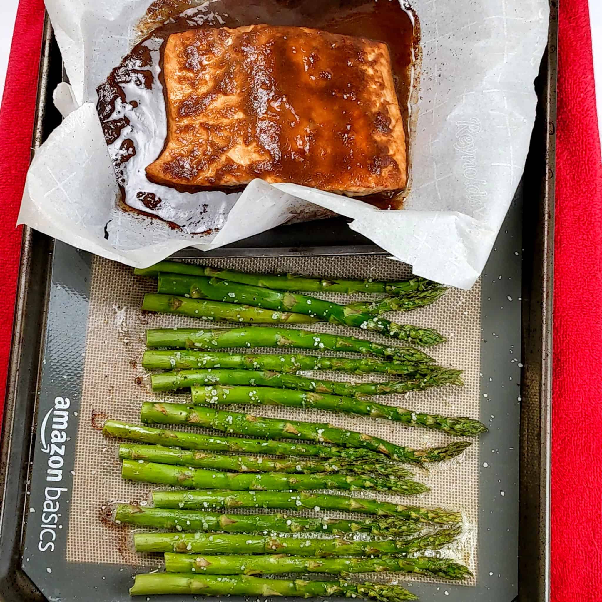 baked miso salmon filet and asparagus on a sheet pan.