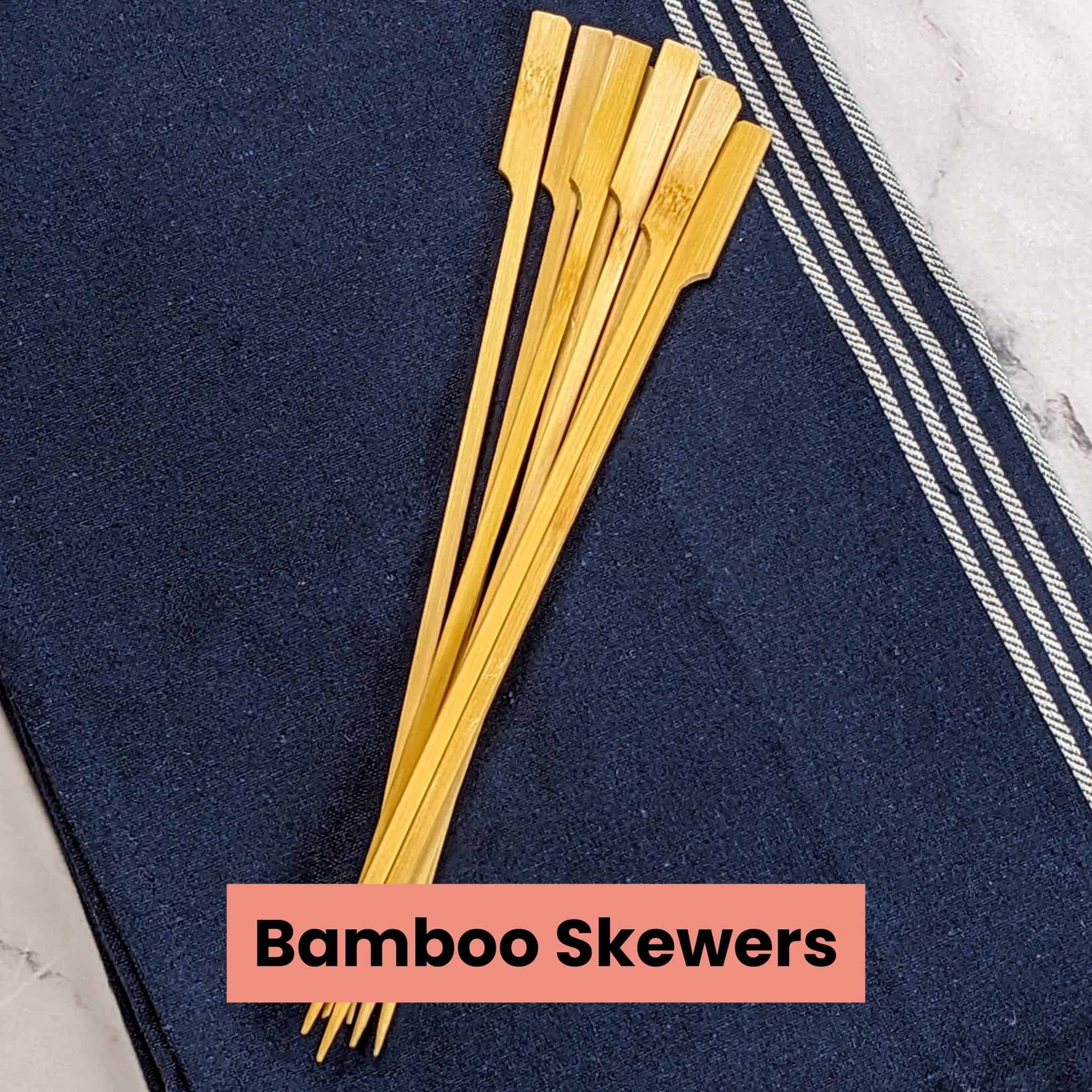 flat wooden bamboo skewers on a kitchen towel.