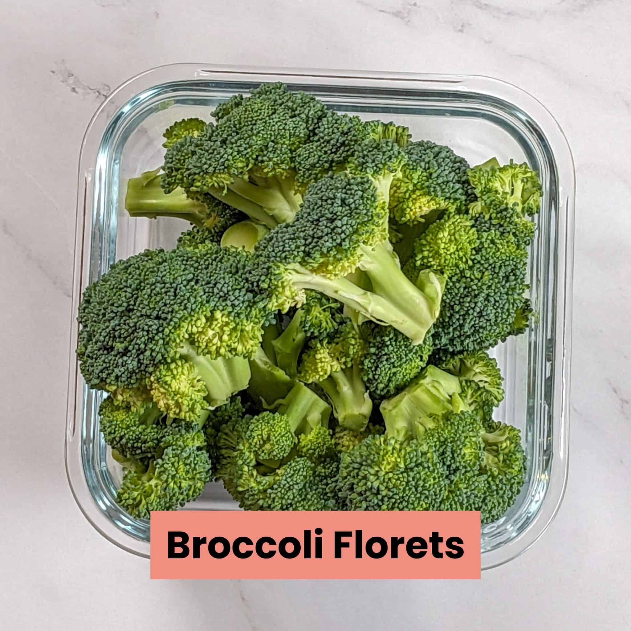 broccoli florets in a square glass container.