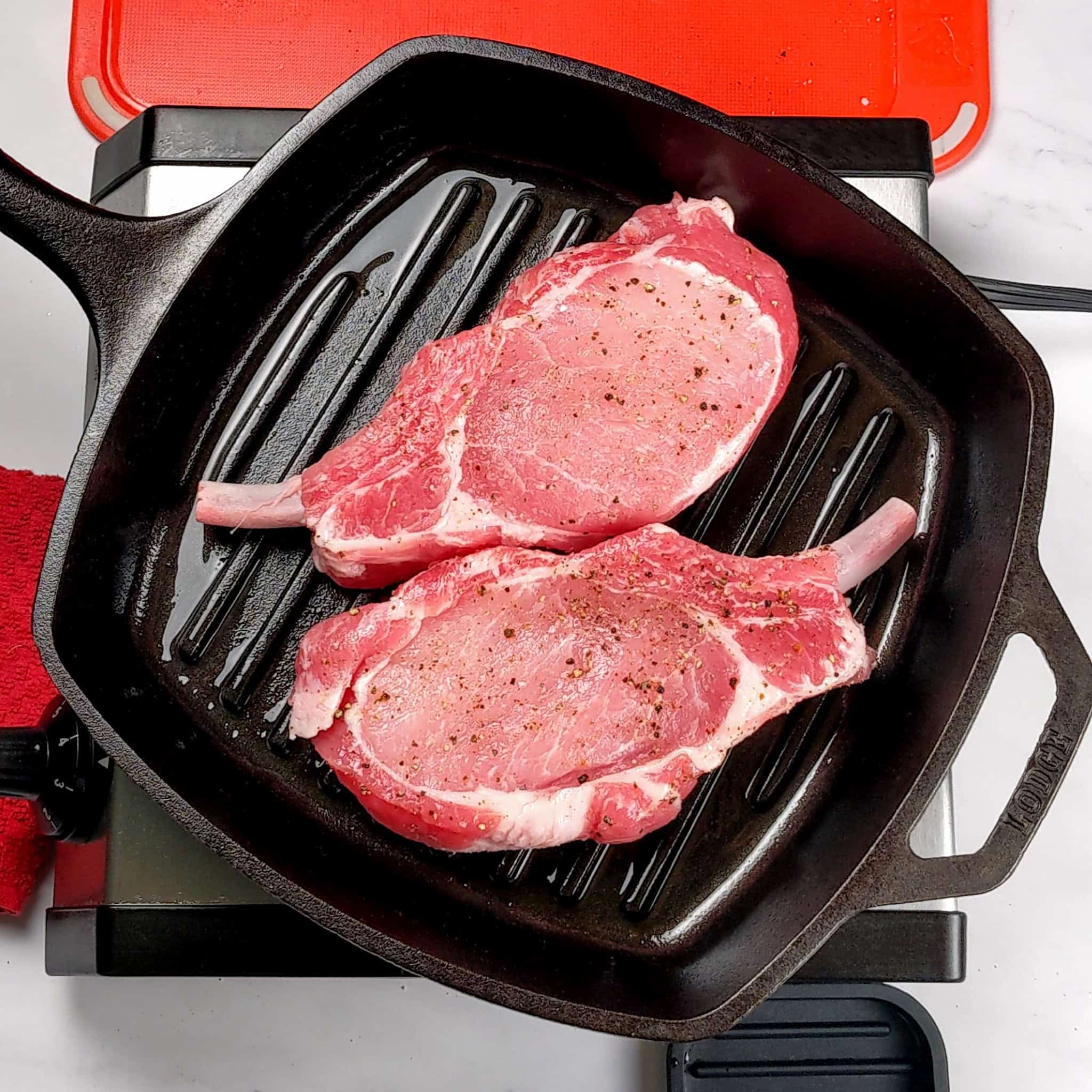 seasoned rib pork chops in a grill pan.