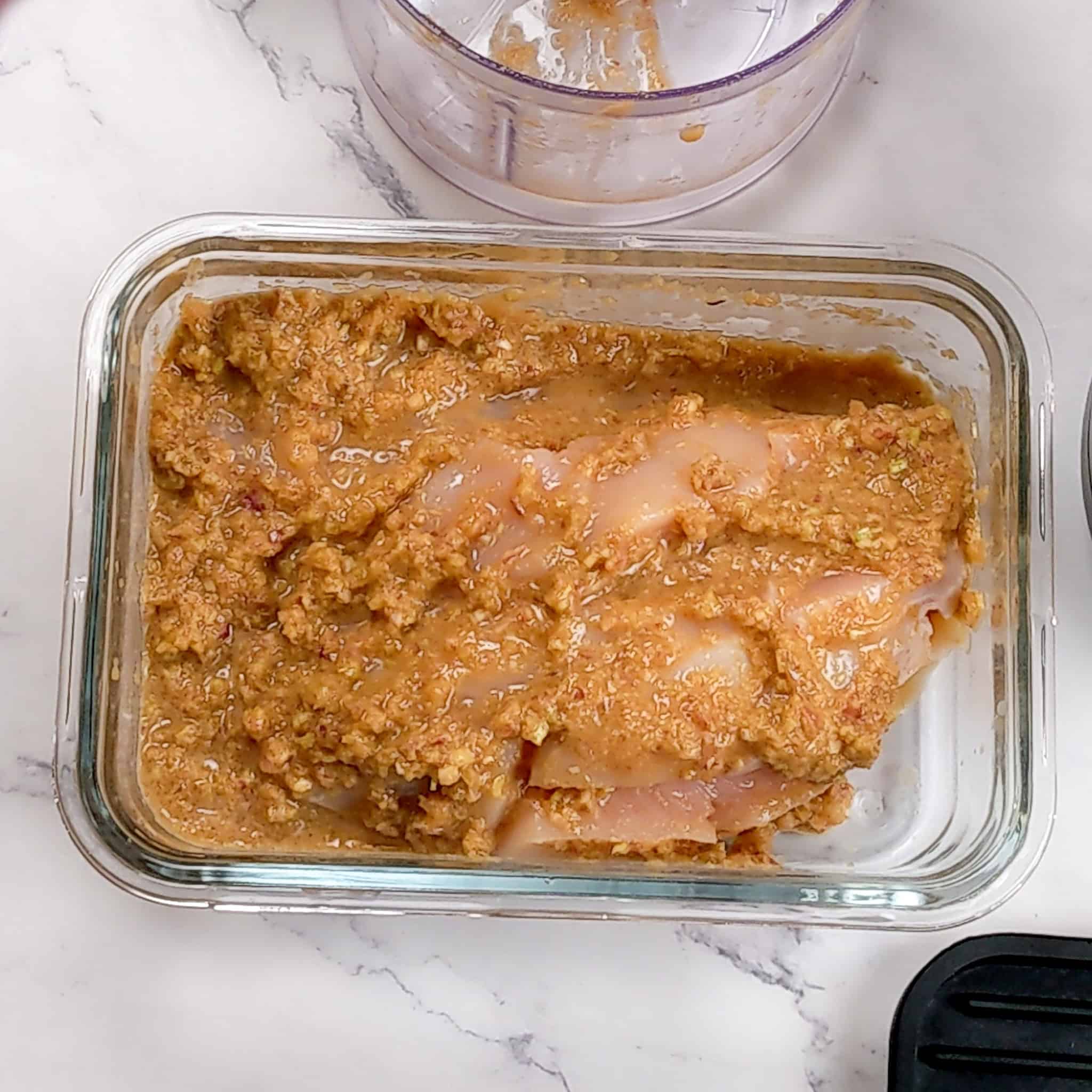 lemongrass marinated chicken breast in a glass rectangle container.