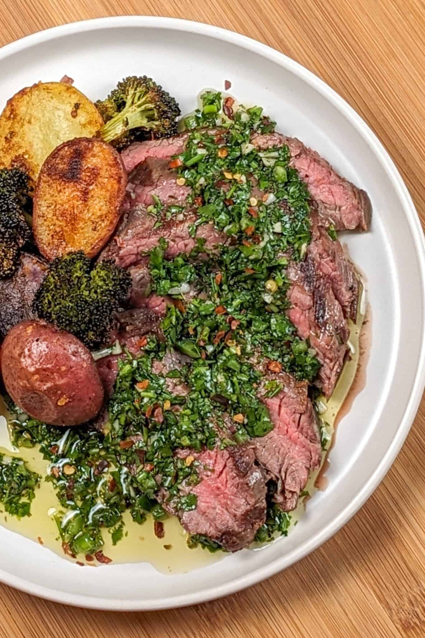 Grilled Steak with Spicy jalapeno Chimichurri sauce with a medley of roasted Baby Potatoes and Broccoli florets.