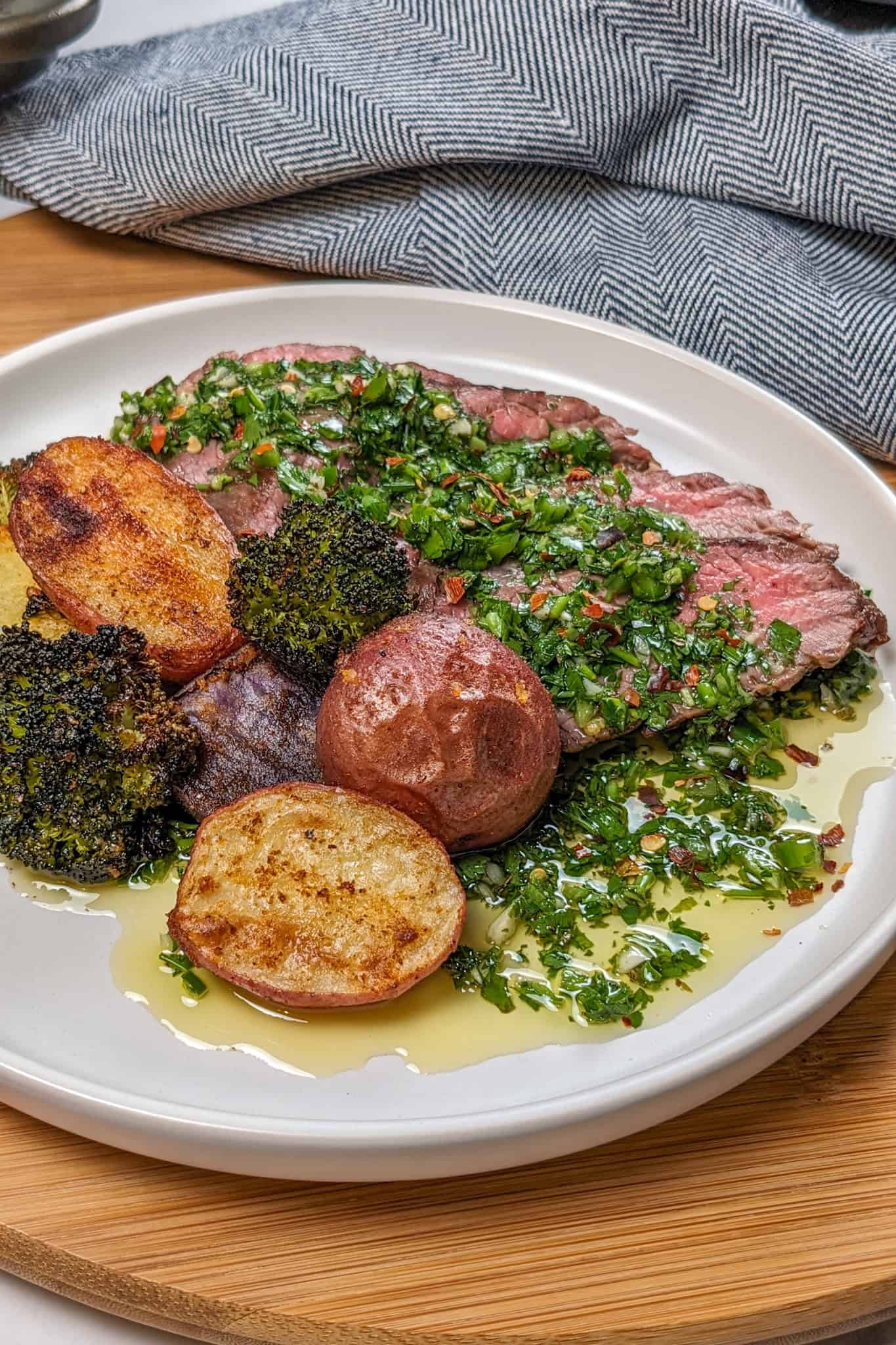 Grilled Steak with Spicy jalapeno Chimichurri sauce with a medley of roasted Baby Potatoes and Broccoli florets.