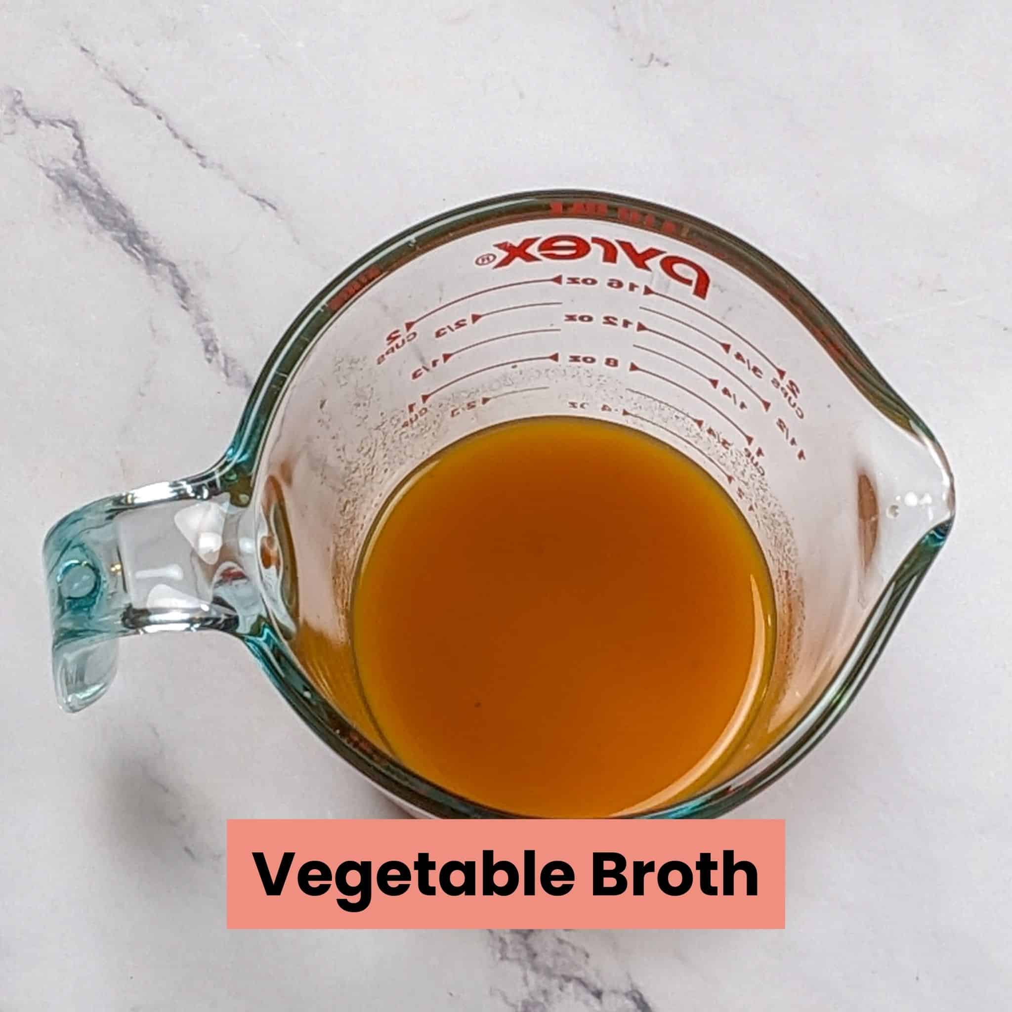 vegetable broth in a pyrex glass measuring cup.