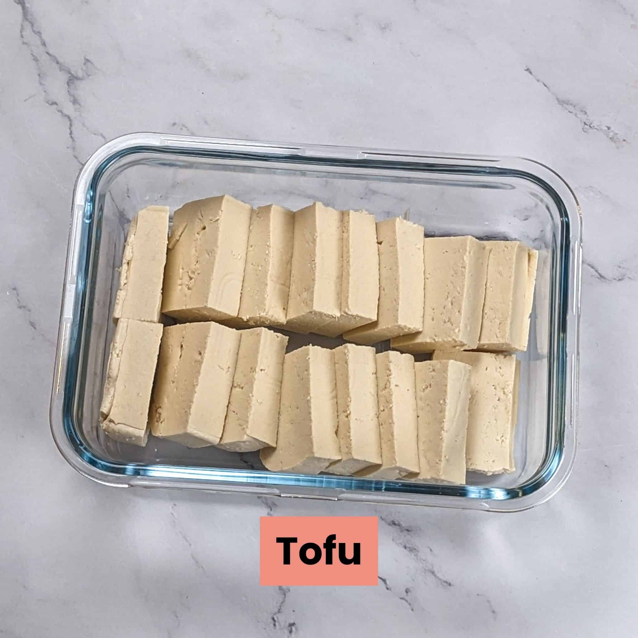 sliced tofu in a glass rectangle container.