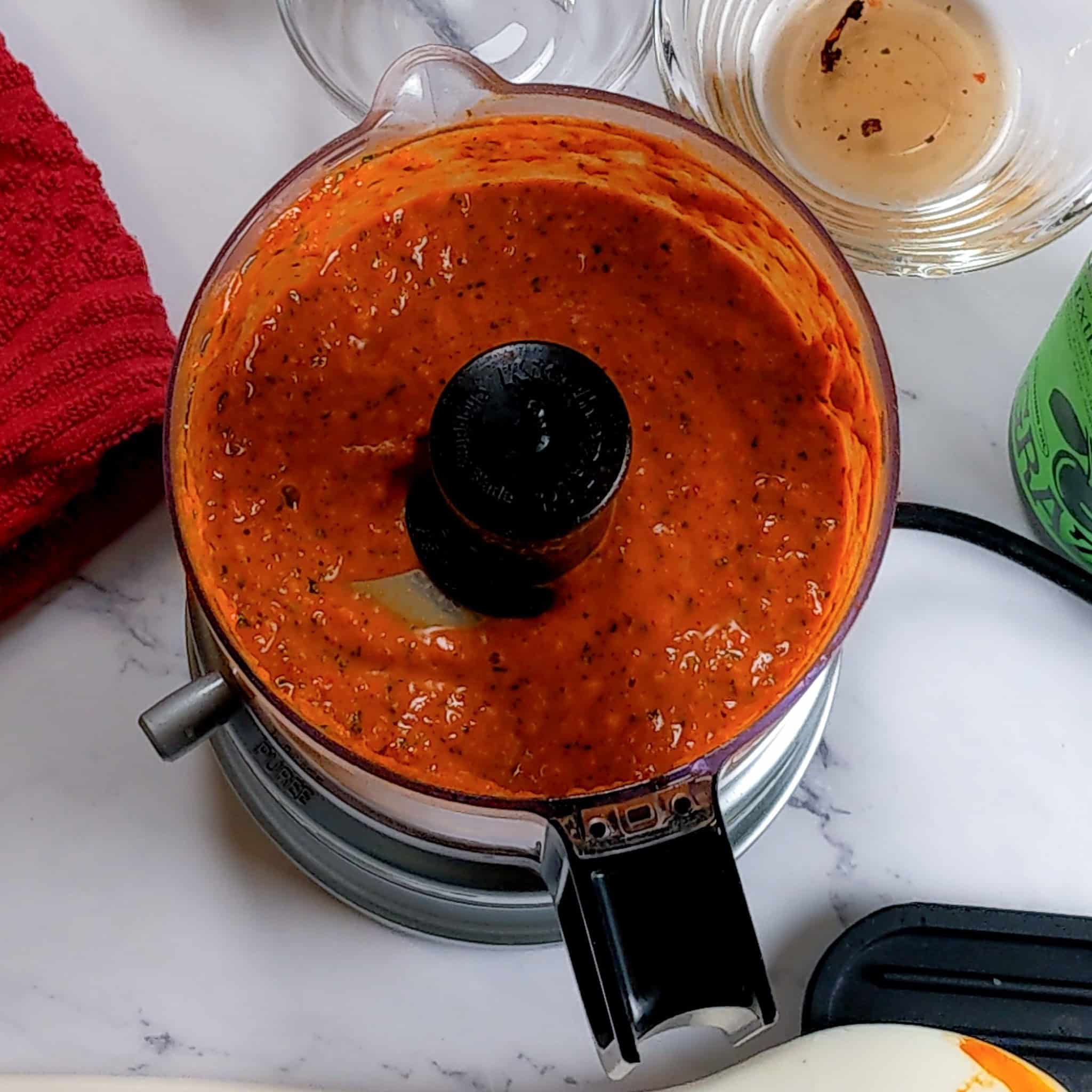 the finished spicy basil romesco sauce in the kitchenaid chopper.