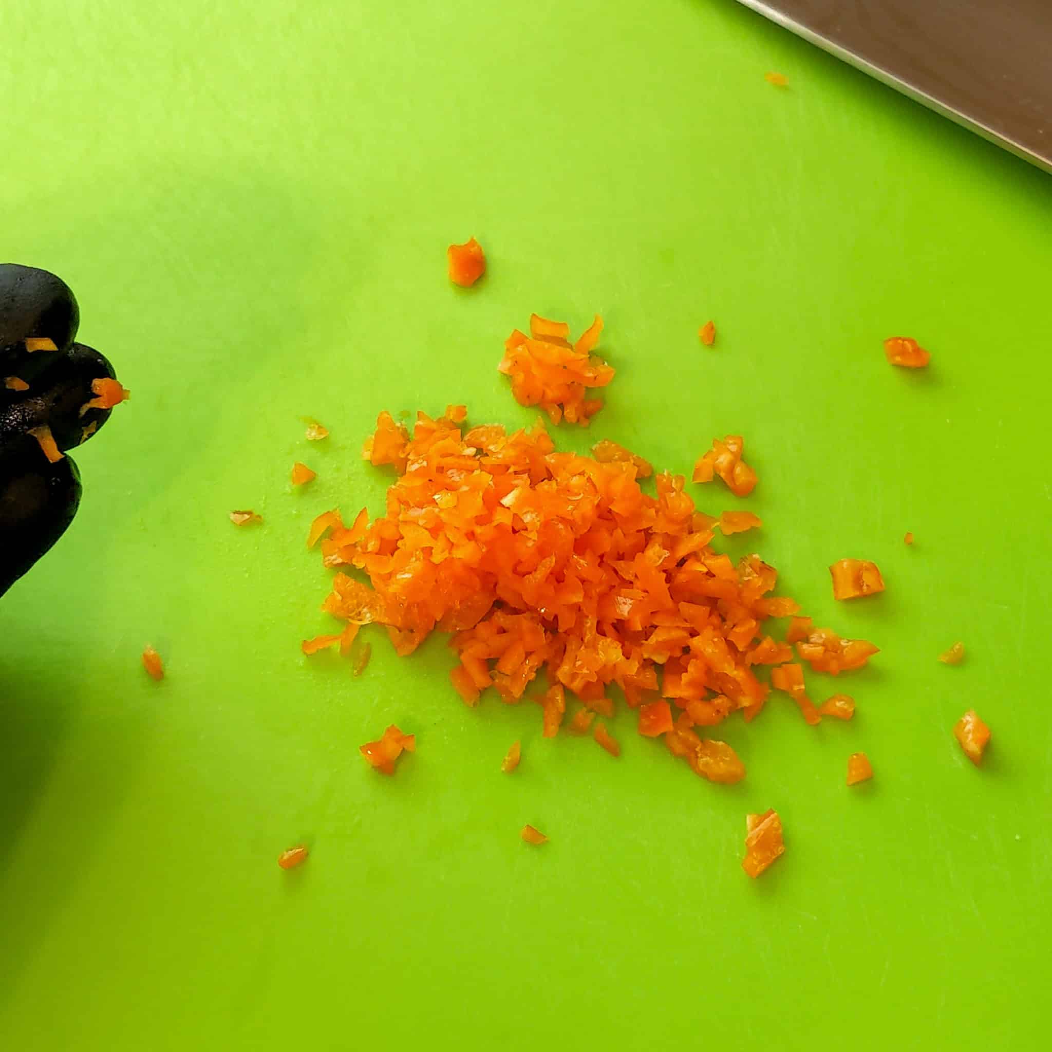 the finished product of chopping chili peppers on a cutting board.