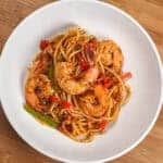 Top view of the Haitian-style spaghetti with shrimp and creole sauce in a wide-rim pasta bowl.