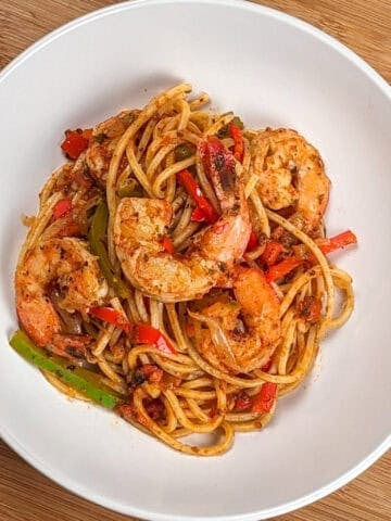 Top view of the Haitian-style spaghetti with shrimp and creole sauce in a wide-rim pasta bowl.