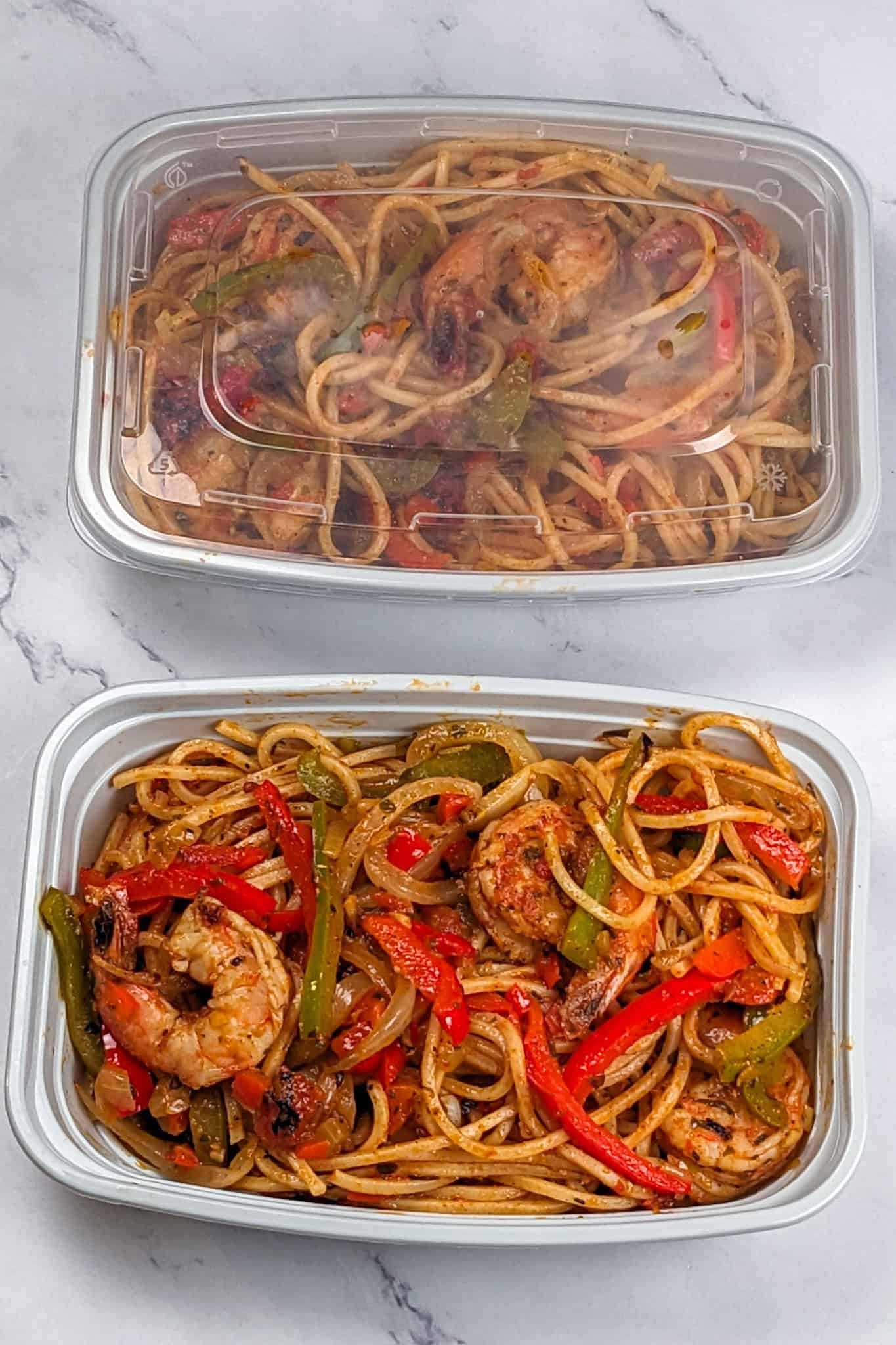 Leftover Haitian-style spicy shrimp pasta and meal prep containers.