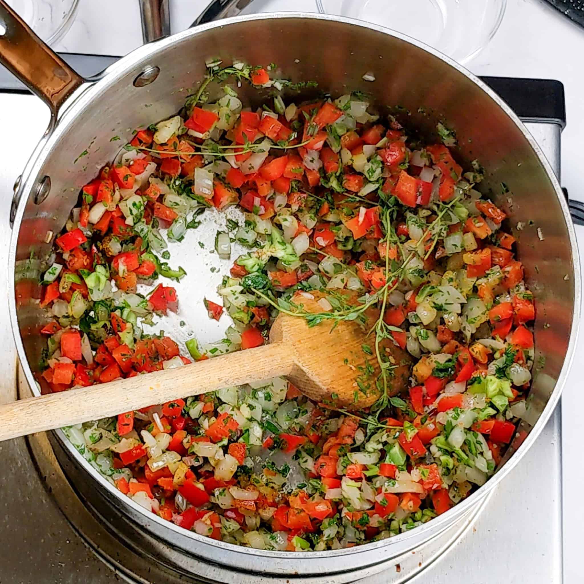 All the vegetables are combined in the All-Clad stainless steel large sauce pot.