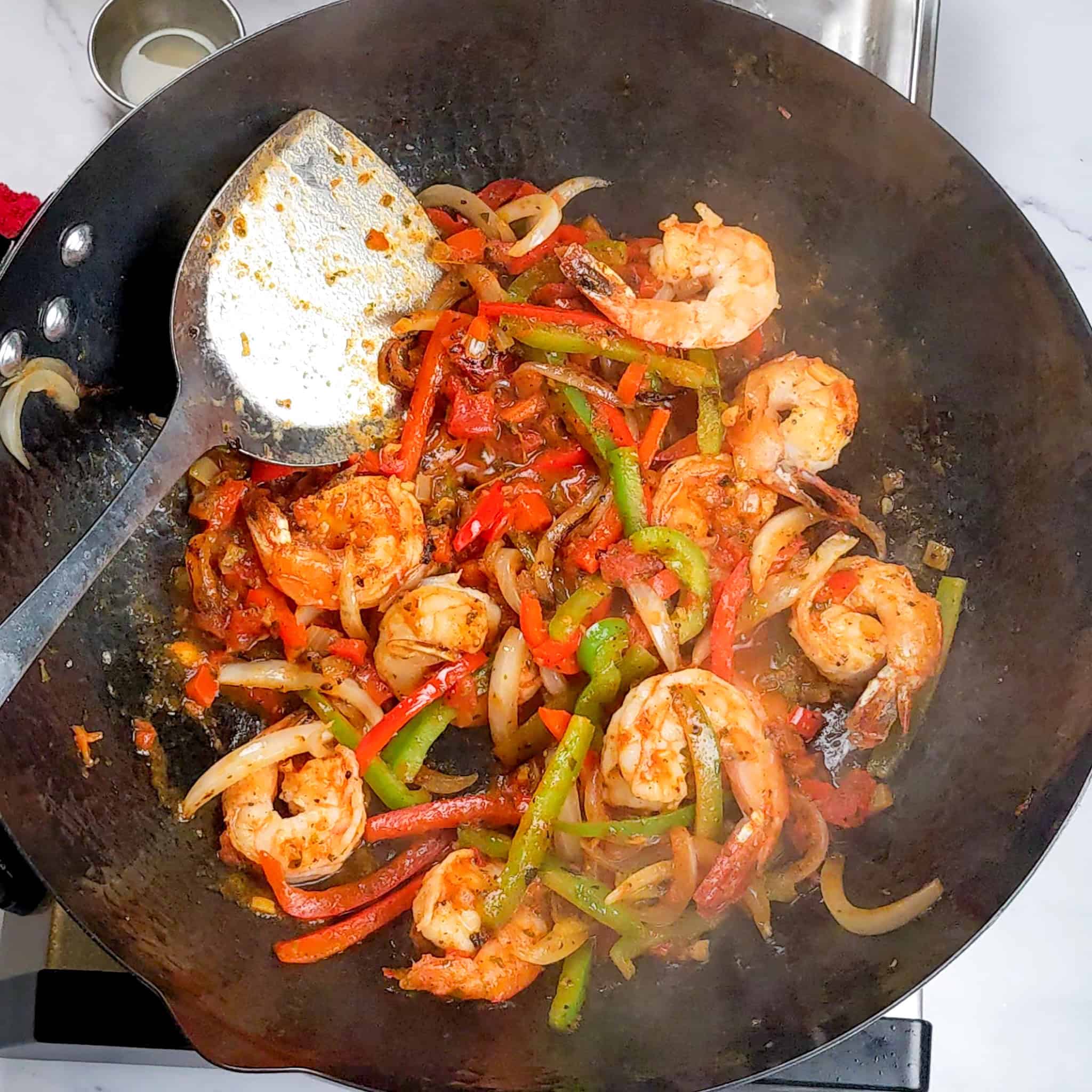 Sauteed vegetable strips were added to the shrimp with the pasta sauce.