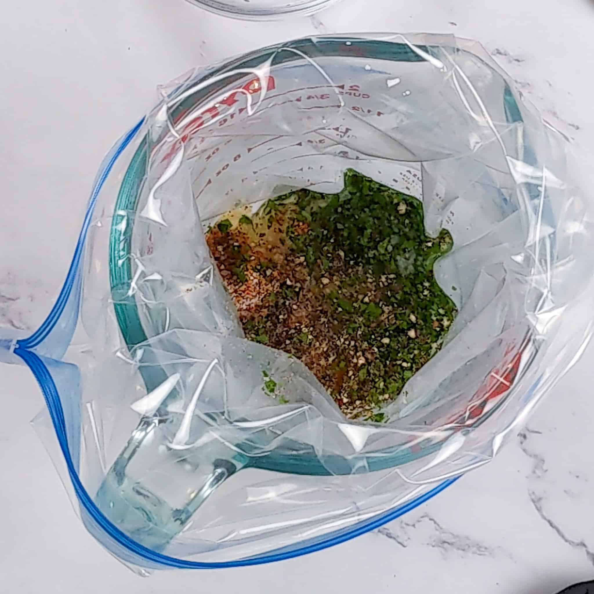 The resealable bag was opened and placed in a Pyrex glass measuring cup Filled with marinade.