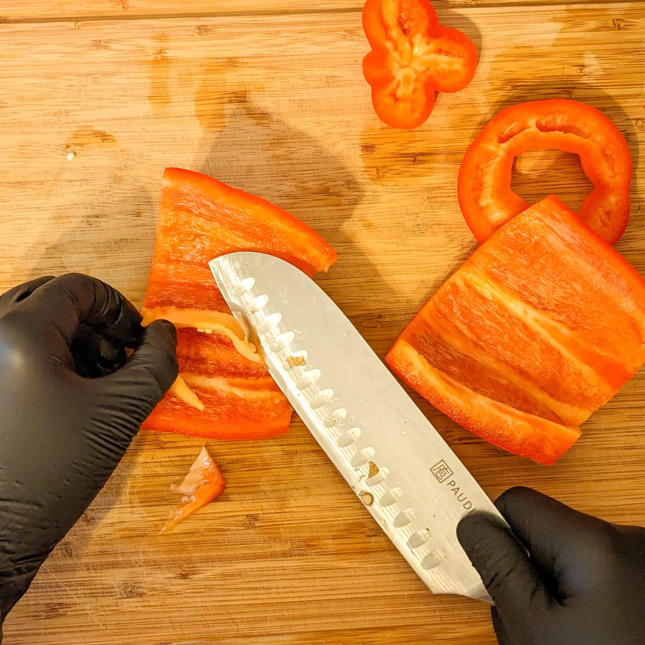 The knife removes the pith from the bell pepper for Cooking with Sweet Peppers.