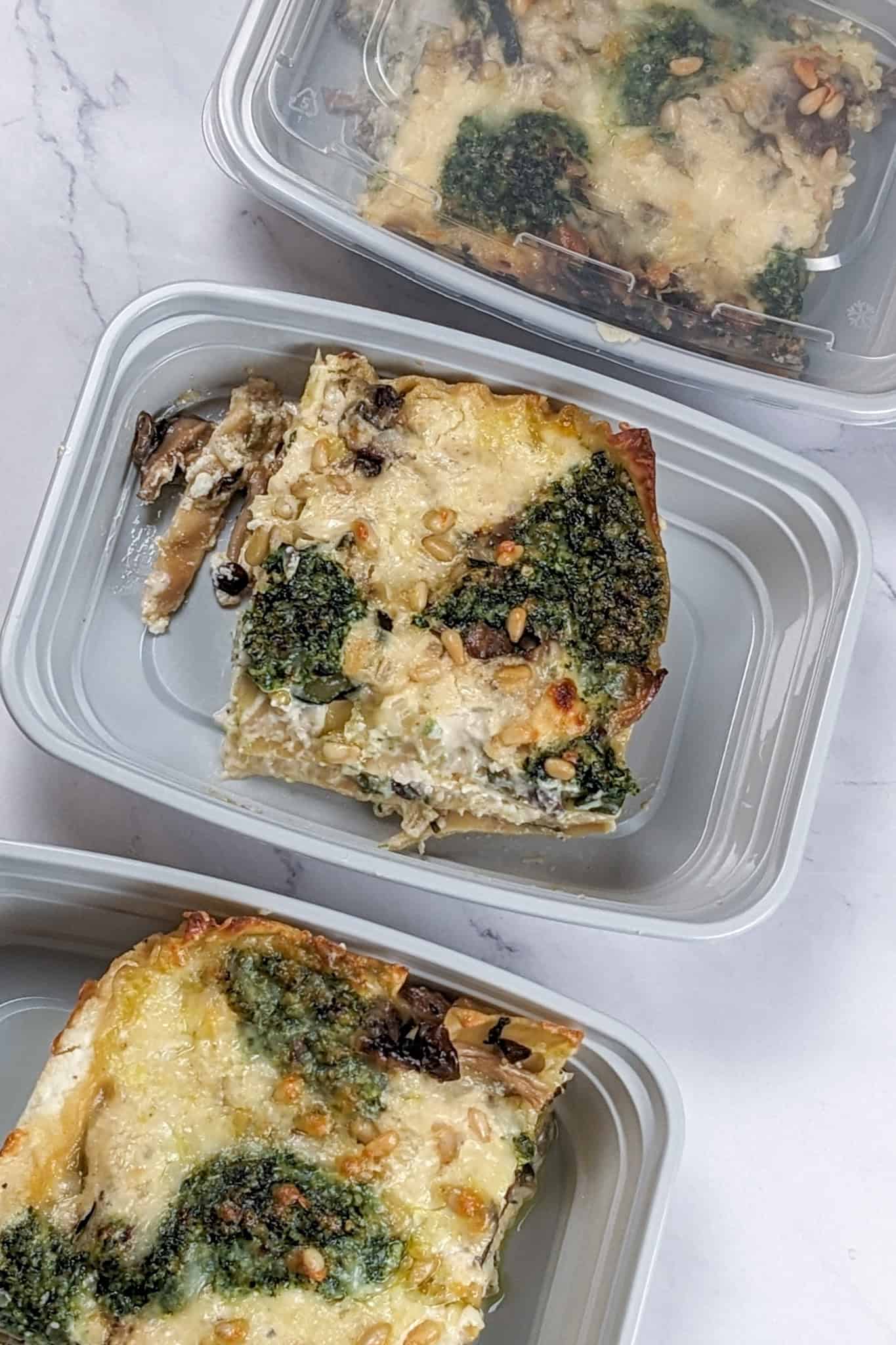 Creamy Spinach Pesto Mushroom Lasagna in meal prep plastic containers.