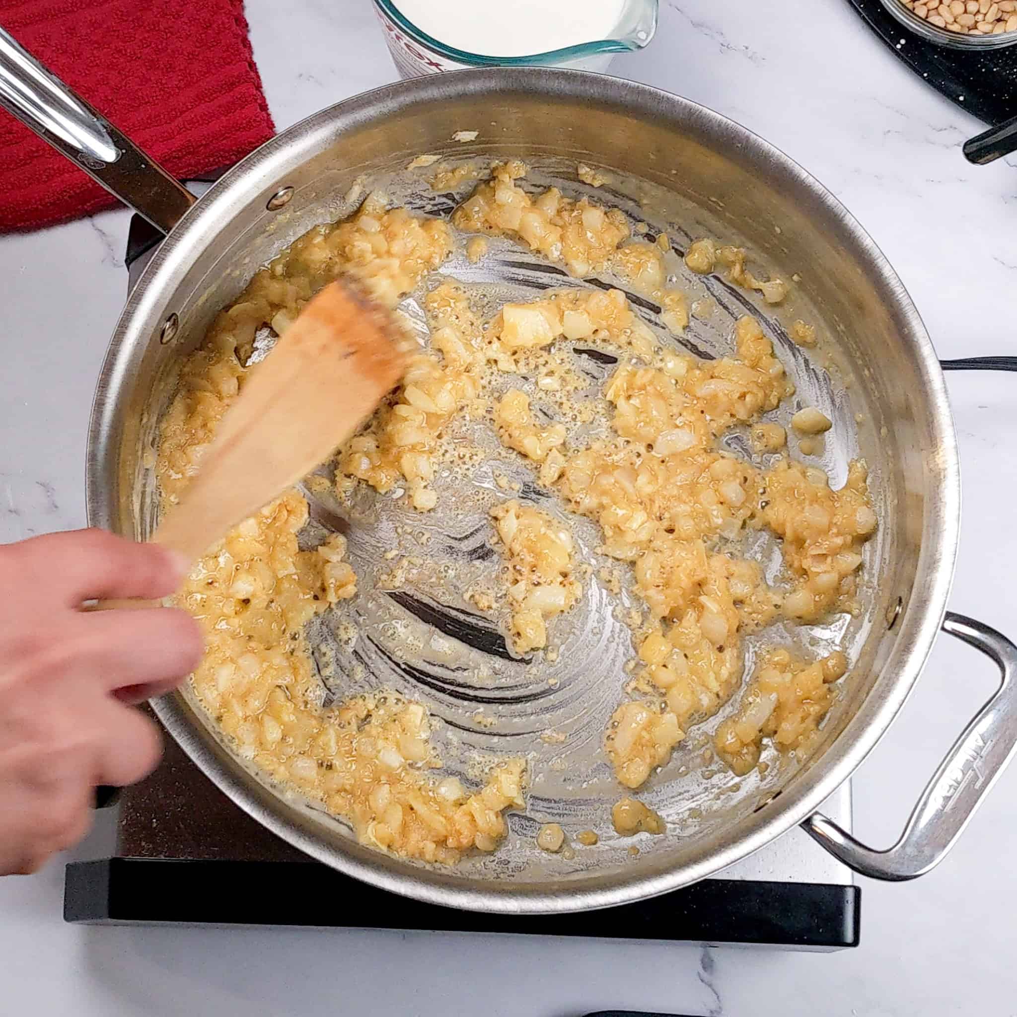 browned onion and garlic mixed with flour thicken while being stirred.