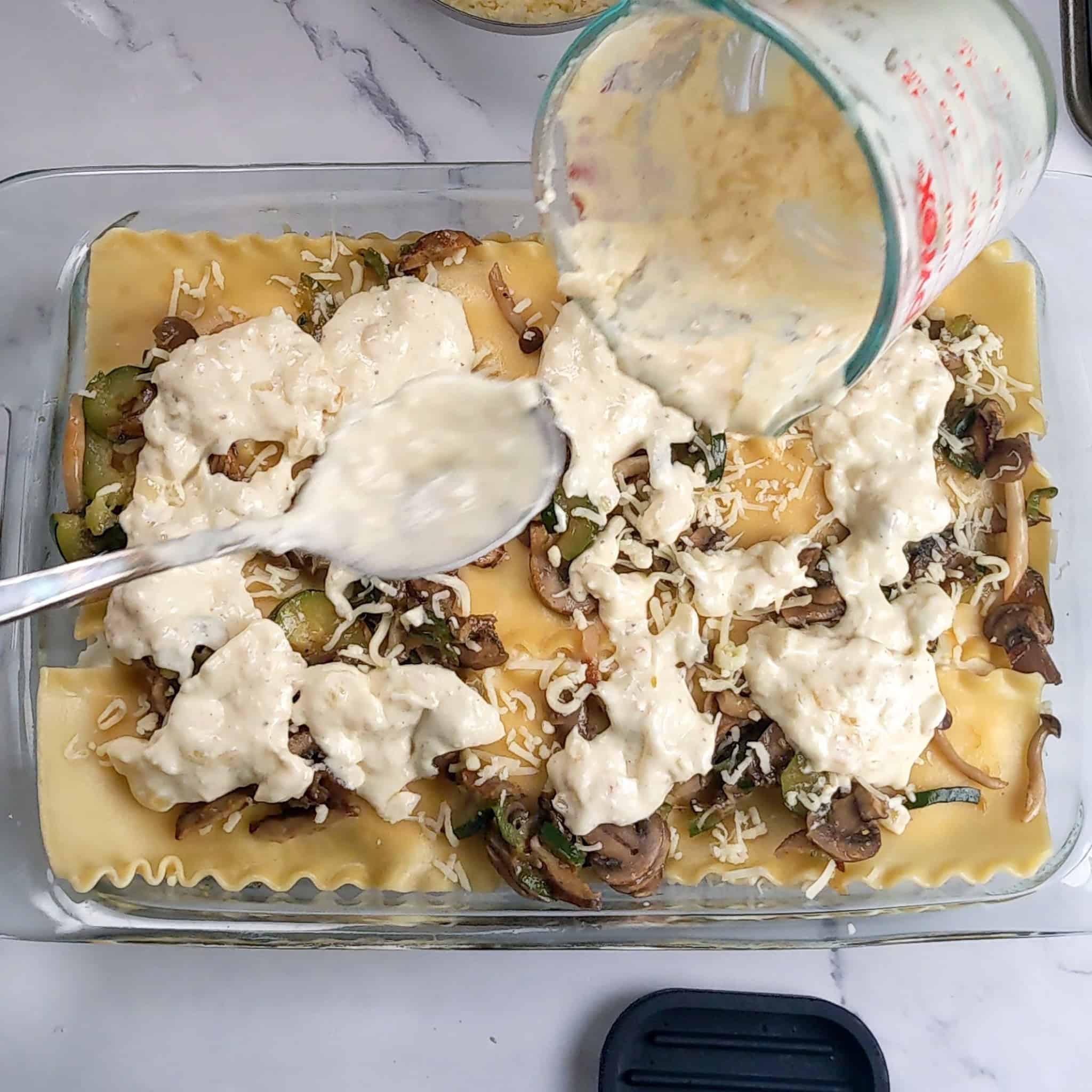 The remaining cream sauce is added.