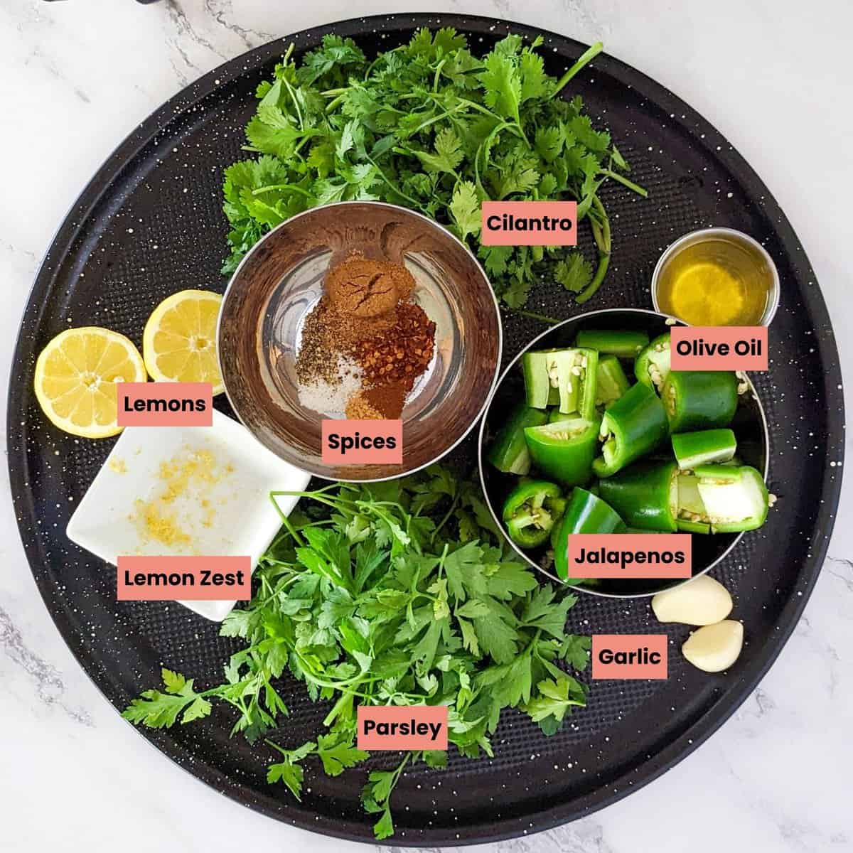 labeled ingredients for the quick zhug sauce on a large round tray in containers.