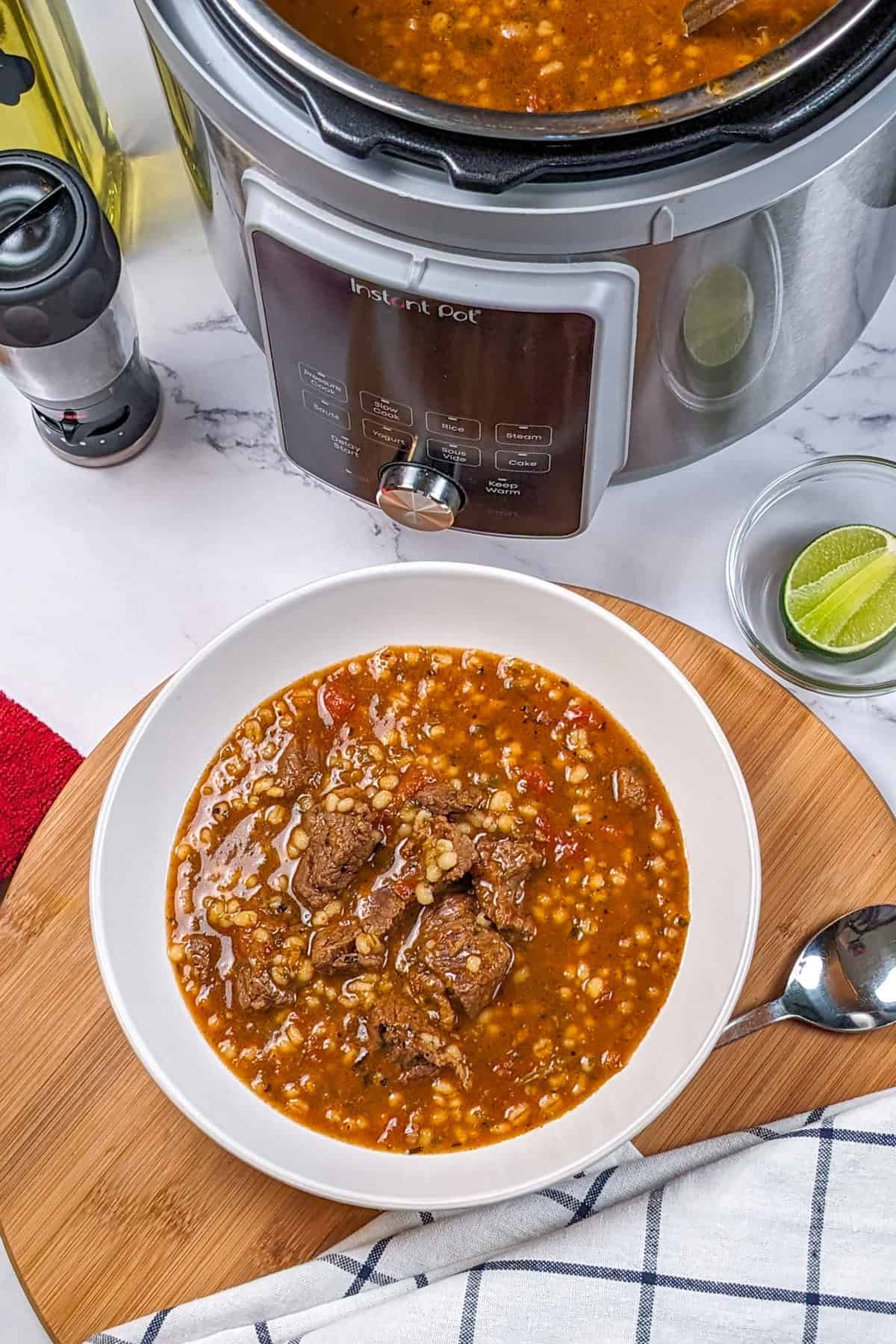 Hearty spicy beef barley stew served in a white bowl, perfect for comfort food lovers.