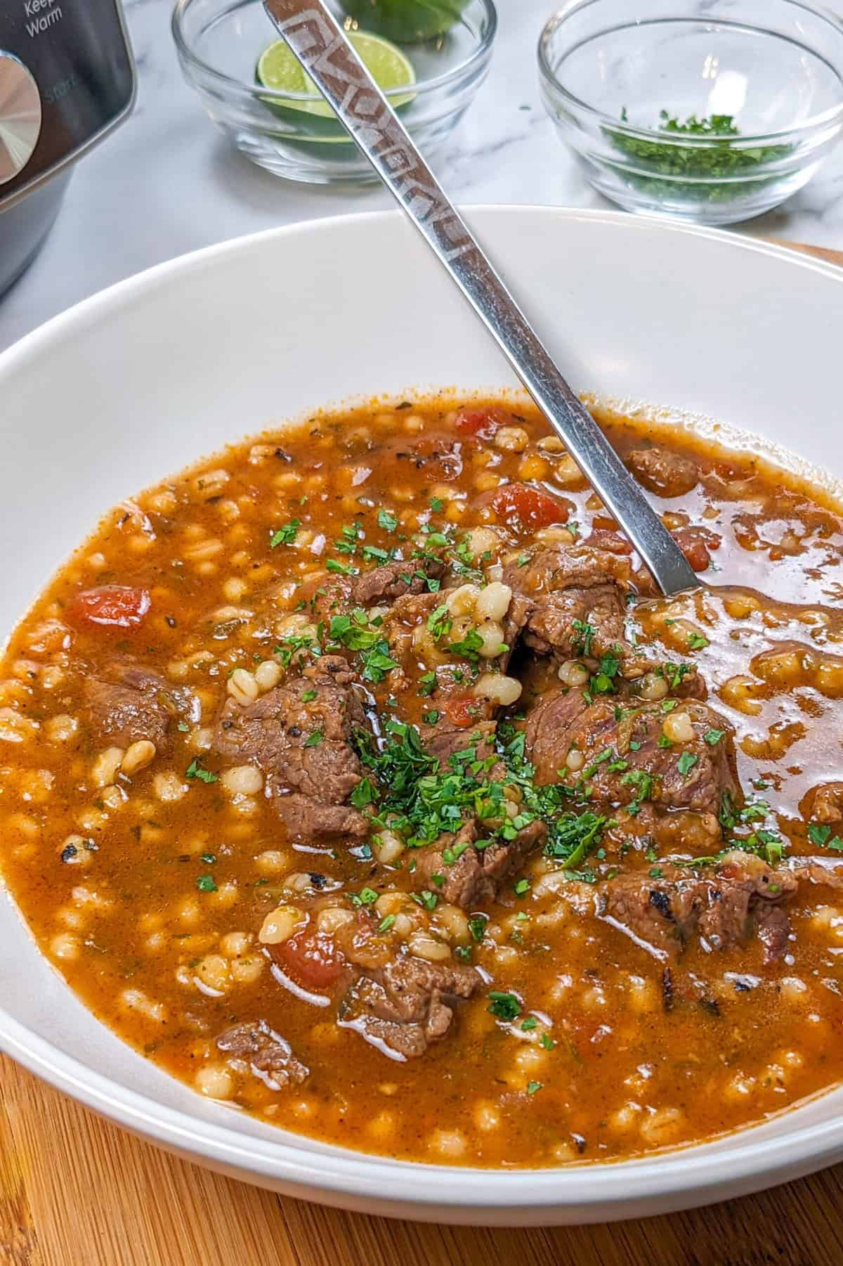 Hearty spicy beef barley stew with rich broth, tender meat, and fresh herbs.