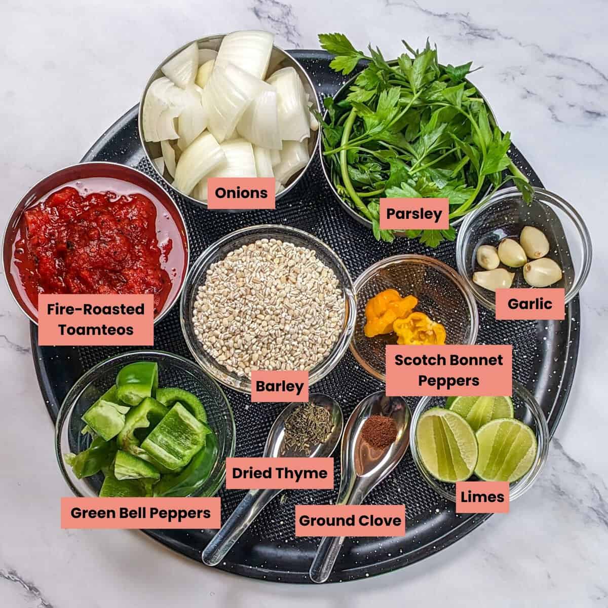 Colorful ingredients for spicy beef barley stew arranged on a round tray for cooking.