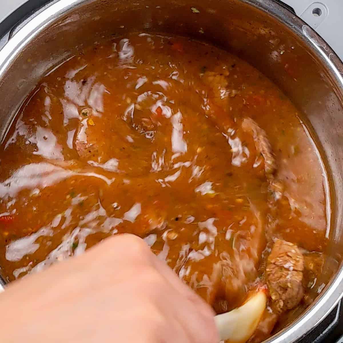 Rich beef barley stew simmering on the stovetop, creating a comforting, savory aroma.