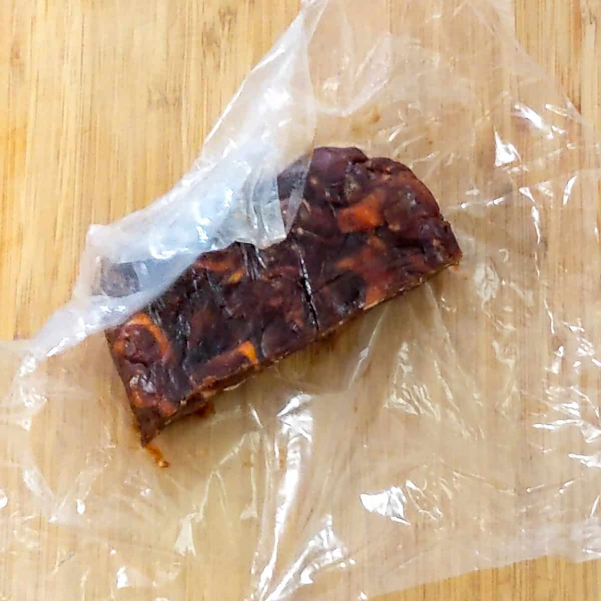 half of a tamarind block with it's plastic wrapper open.