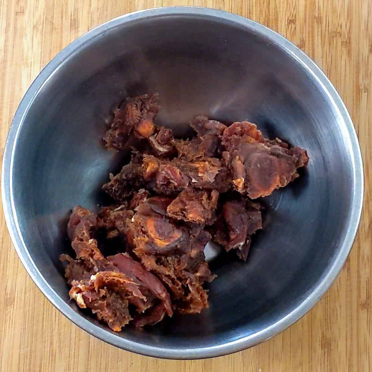 torn tamarind pulp in a mixing bowl.