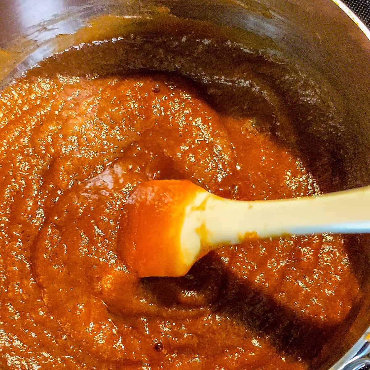 tamarind paste changing while being heated on the stove top.