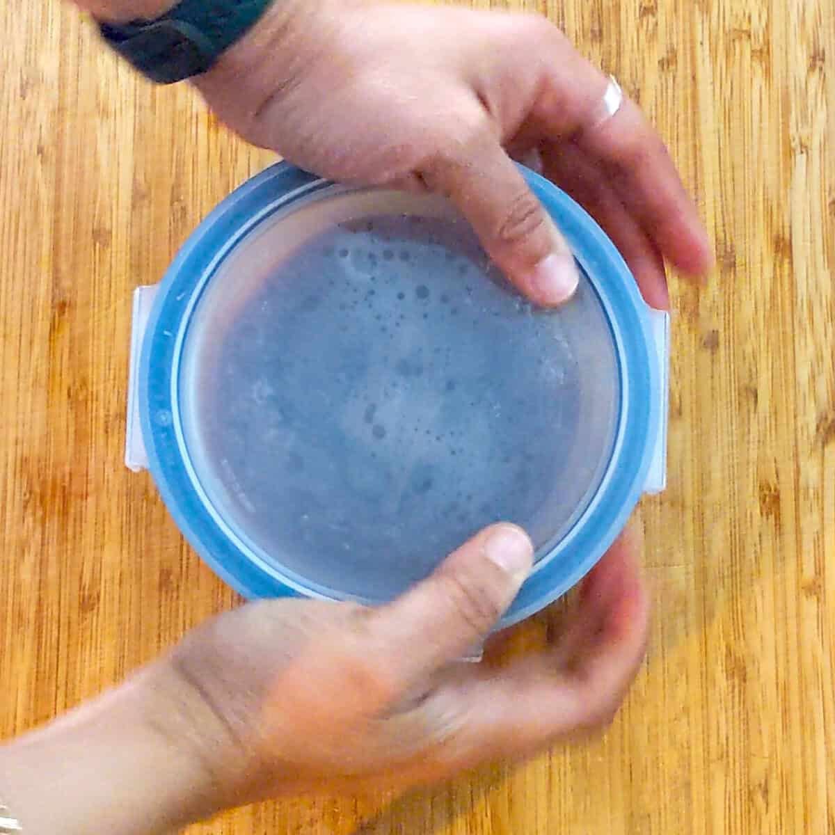 plastic snip on lid being placed over glass container of the finished pulp.