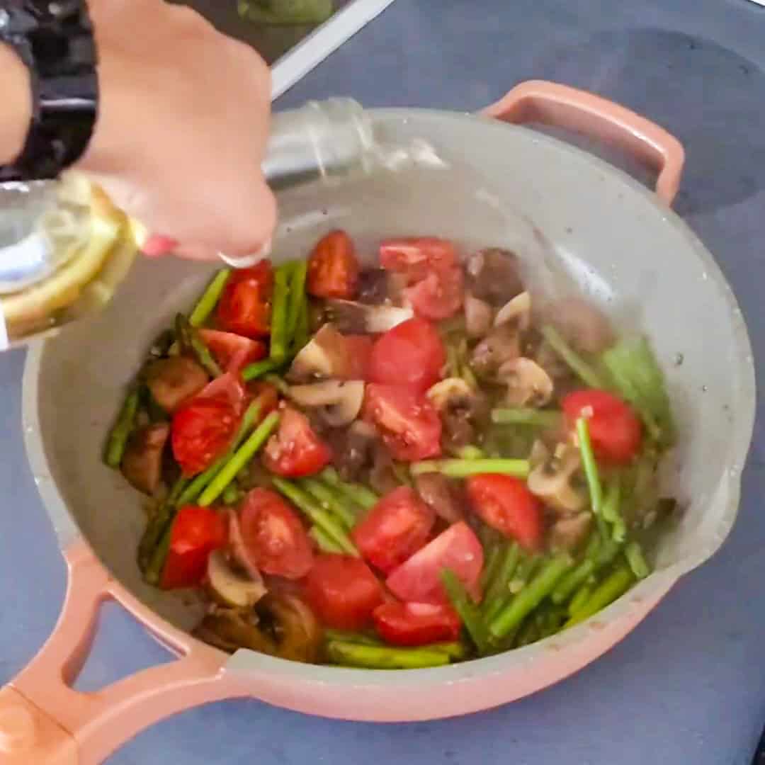 Sautéing fresh vegetables for Argentinian shrimp pesto pasta in a vibrant kitchen setting.