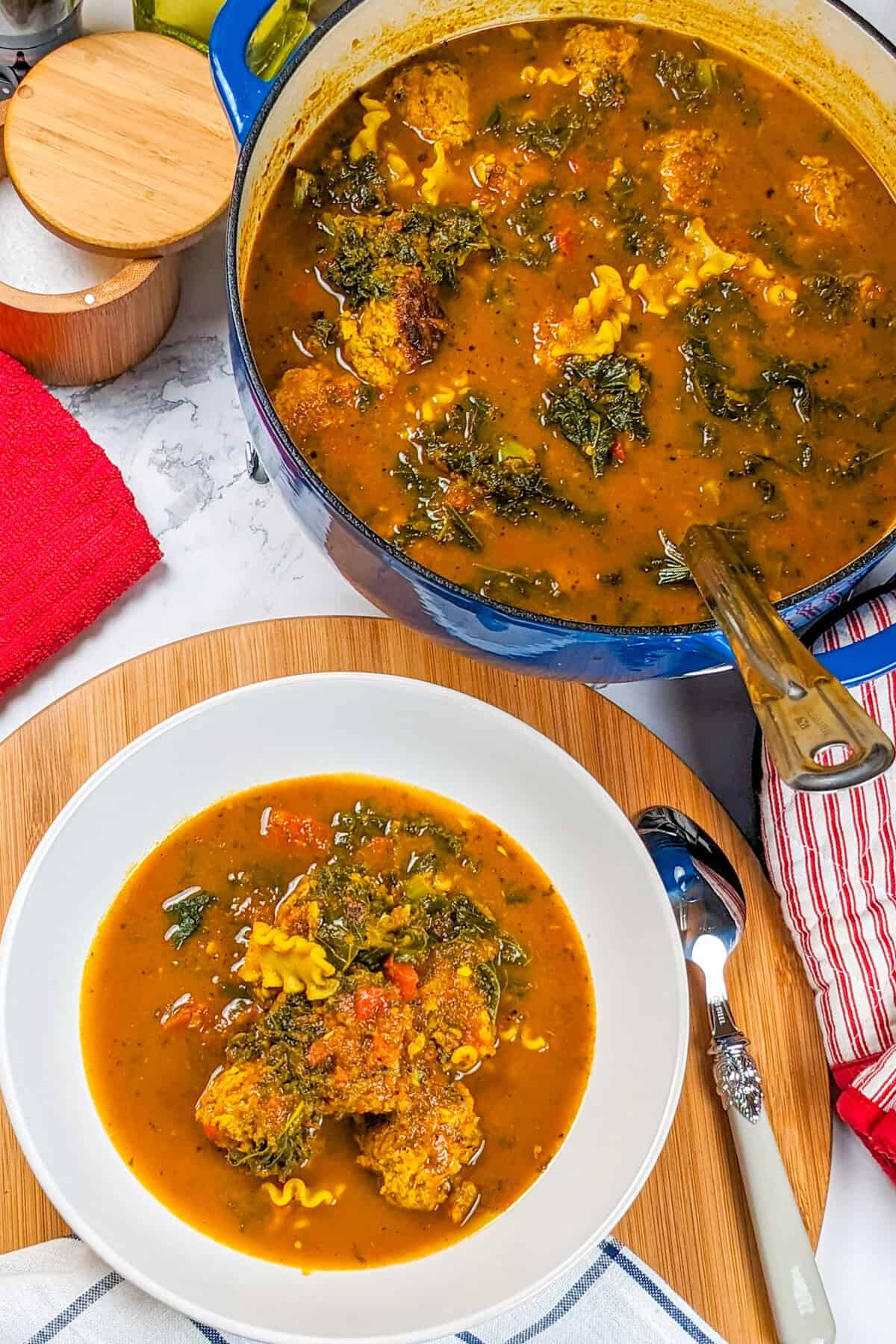 Delicious curry turkey meatball soup served in a bowl and cooking pot, perfect for sharing.