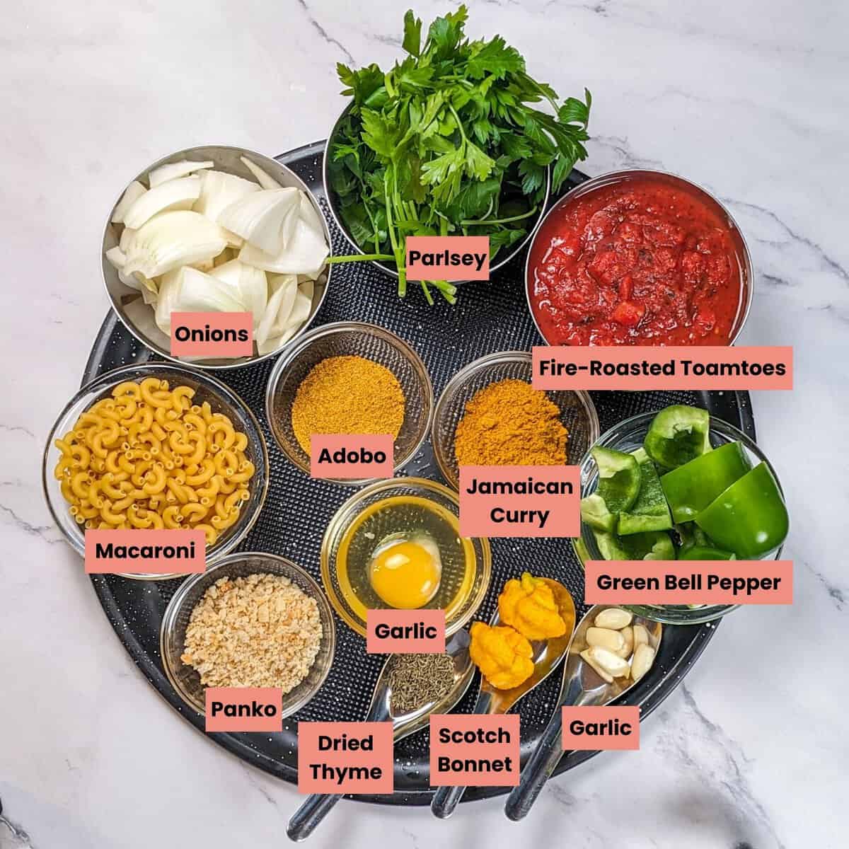 Colorful ingredients for curry turkey meatball soup arranged on a marble surface.