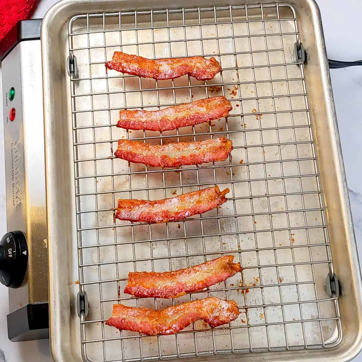 Crispy bacon strips on a baking rack, perfect for enhancing chowder or breakfast dishes.