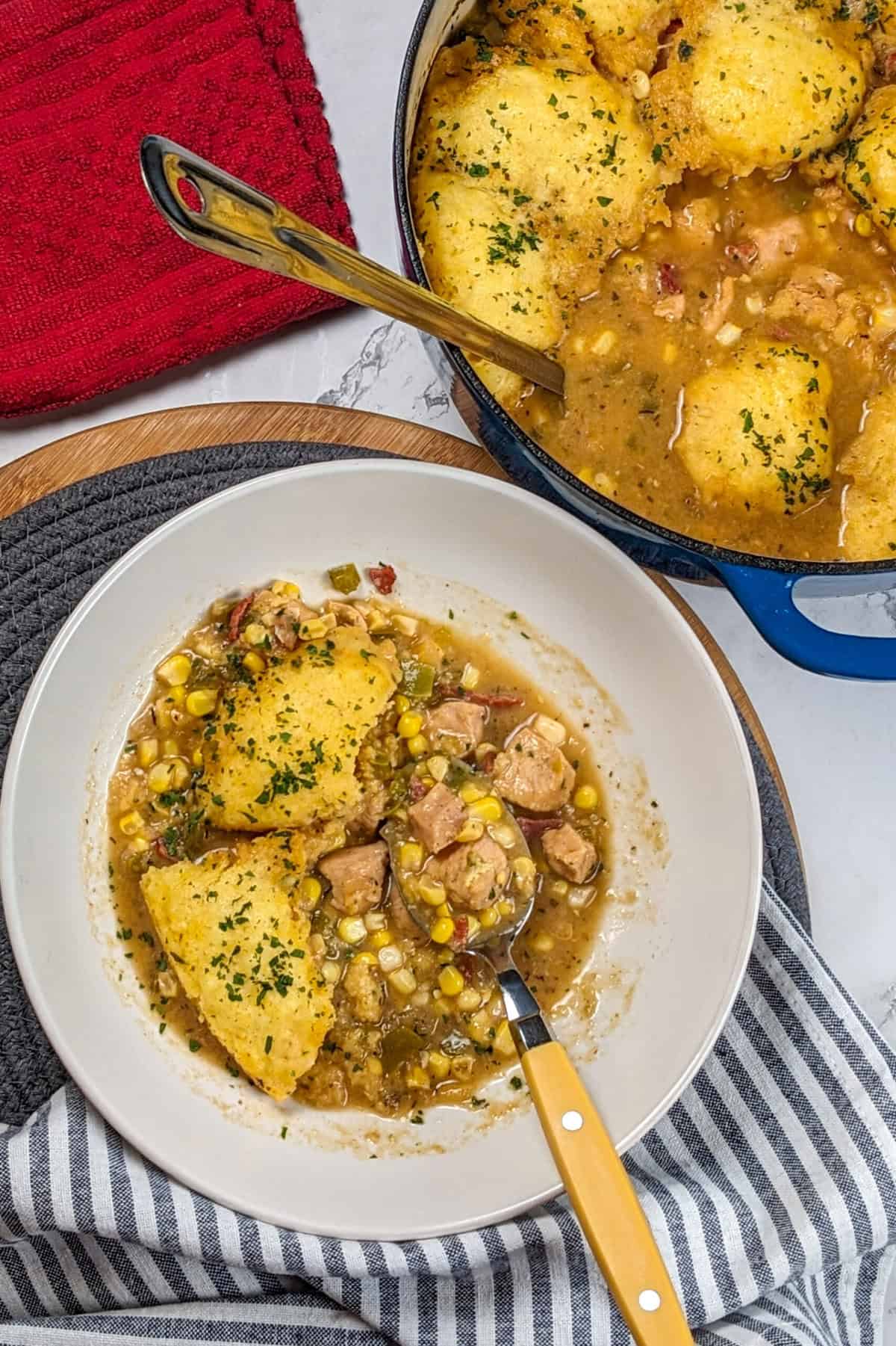 Hearty chicken corn chowder with dumplings in a rustic bowl, perfect for cozy evenings.