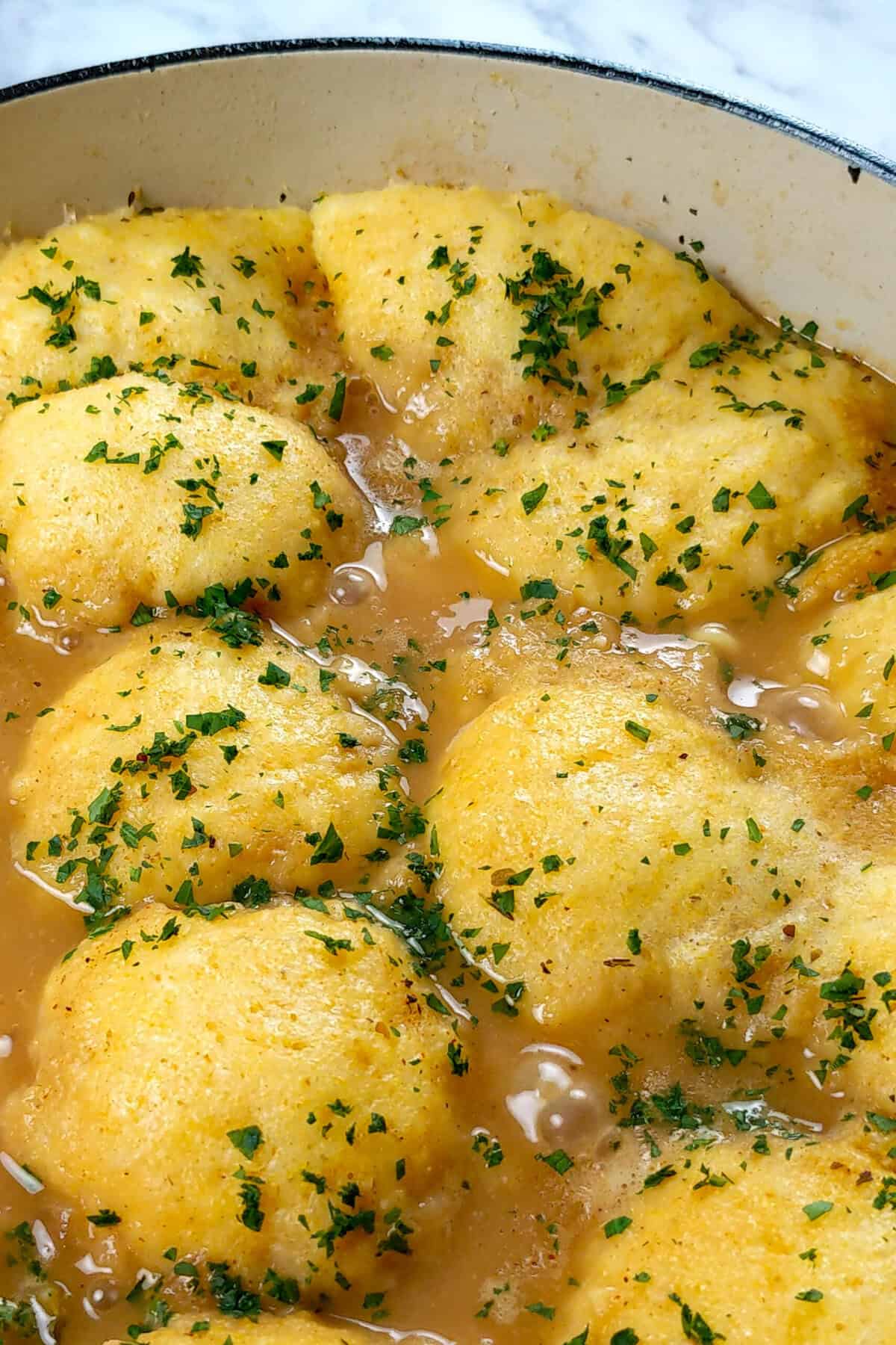 Delicious Chicken Corn Chowder Dumplings in savory broth, garnished with fresh parsley.