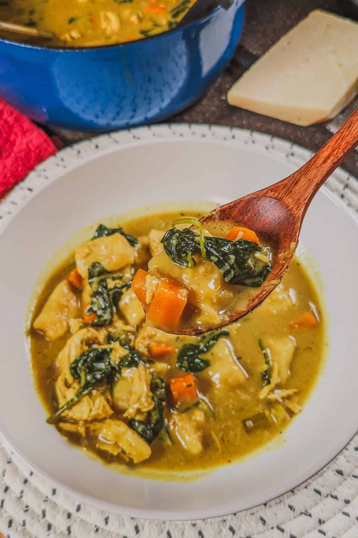 Delicious curry coconut chicken gnocchi soup, vibrant ingredients in a cozy kitchen setting.