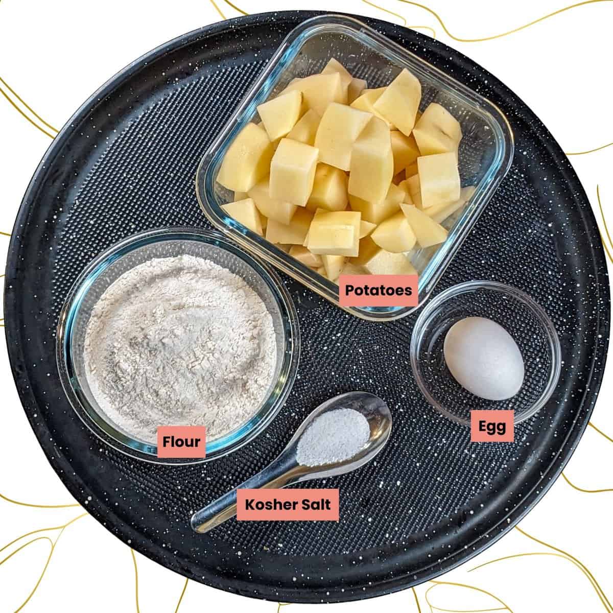 Potato gnocchi  ingredients arranged on a black round tray for easy preparation.