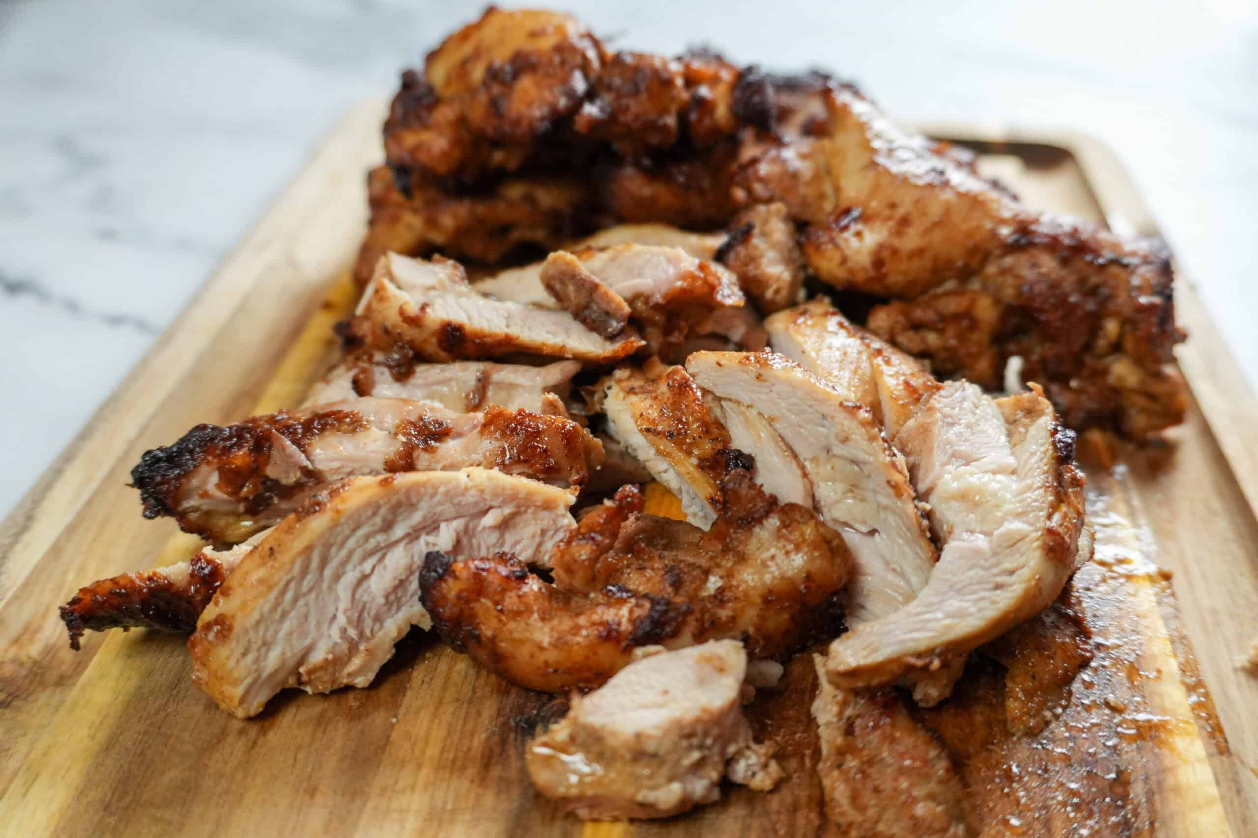 close up of the Beituti Shawarma Chicken Thighs sliced on a cutting board.