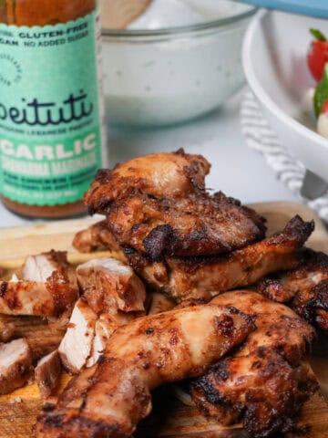 close up of the Beituti Shawarma Chicken Thighs sliced on a cutting board.