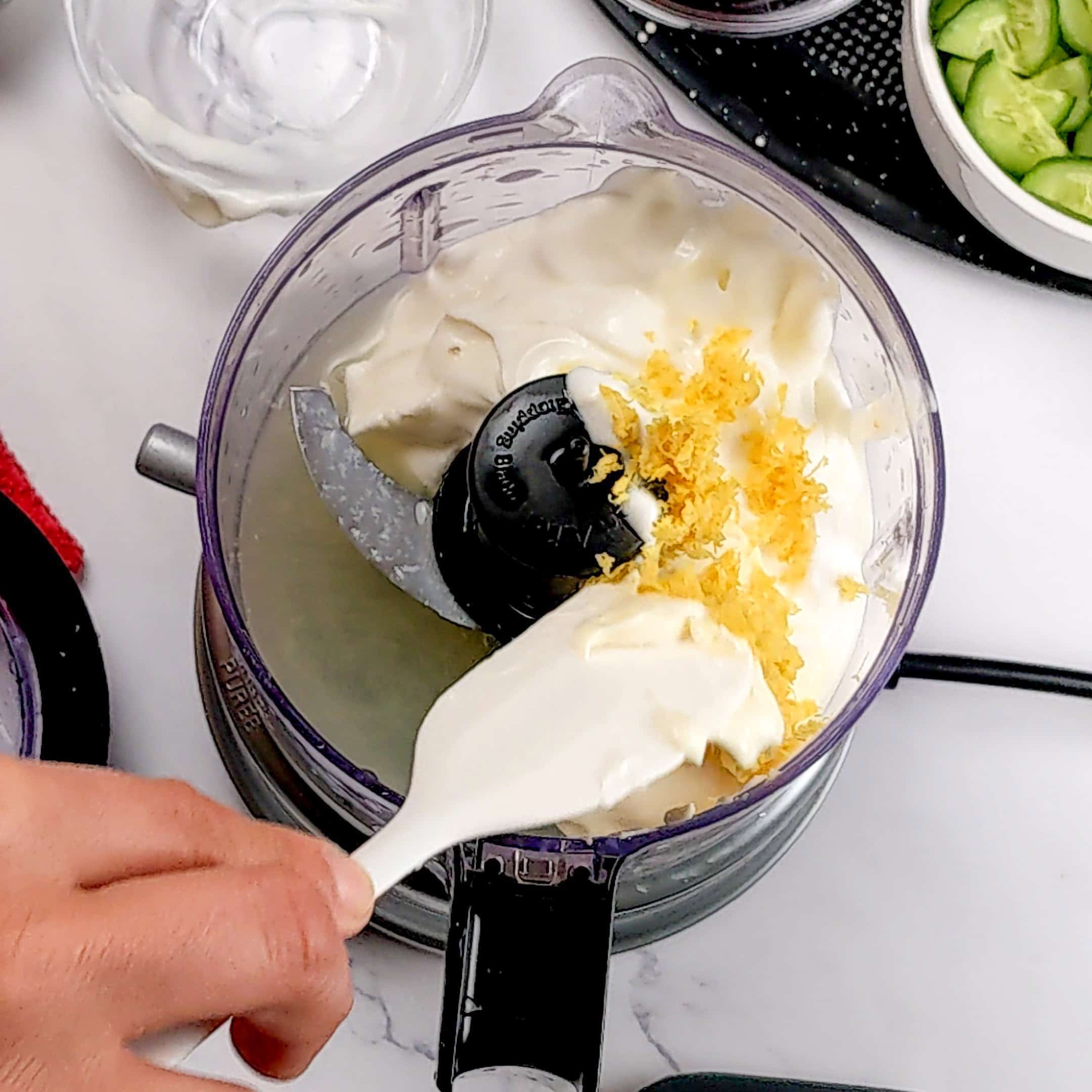 greek yogurt mixture scrapped with a silicone spatula in a food processor.