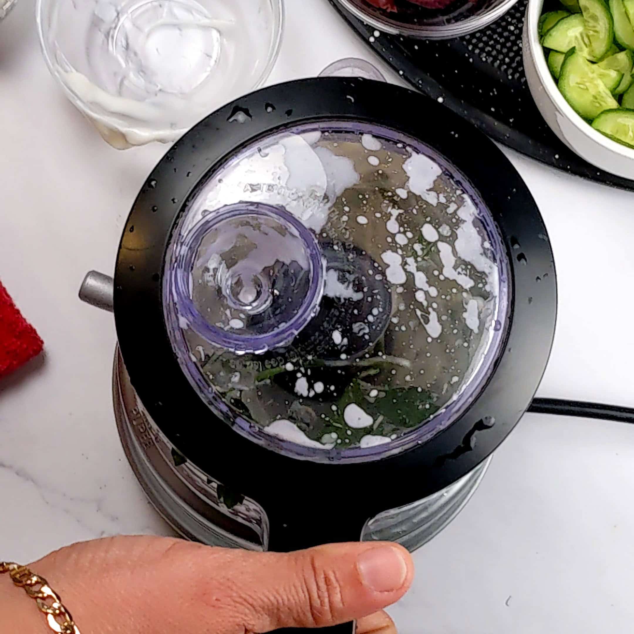 the lemon greek yogurt dressing ingredients being blended in a food processor.