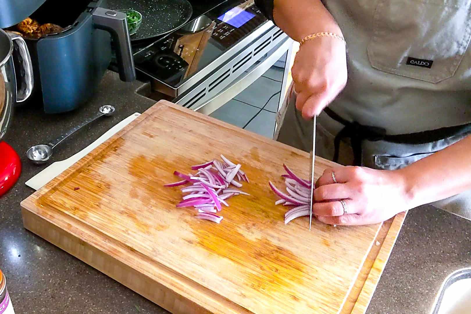 chef maika cutting the sliced onion.