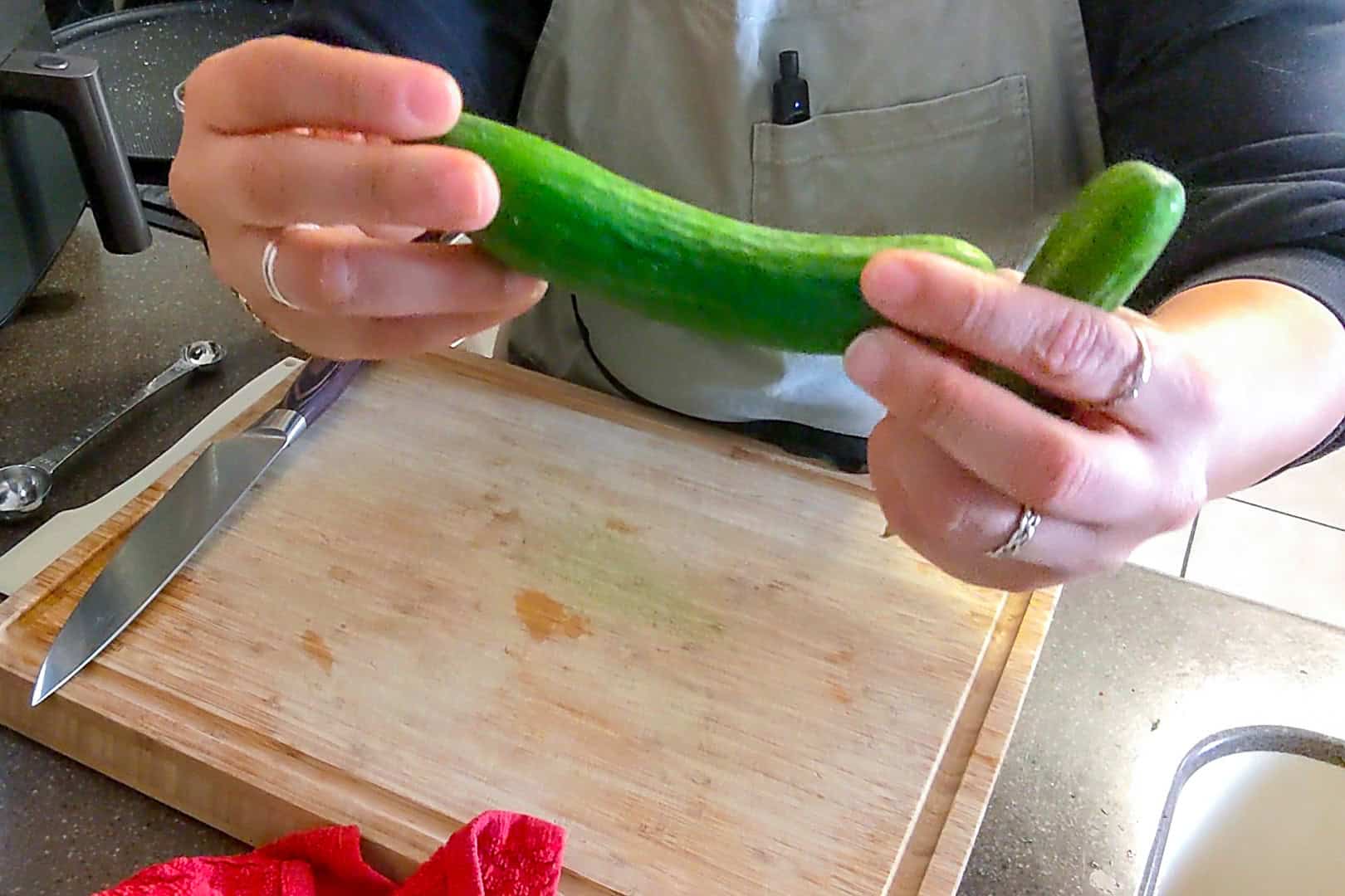 close up of a whole persian cucumber, which looks short and slim compared to a regular kirby cucumber.